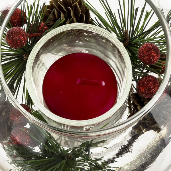 Bougie rouge dans une boule en verre